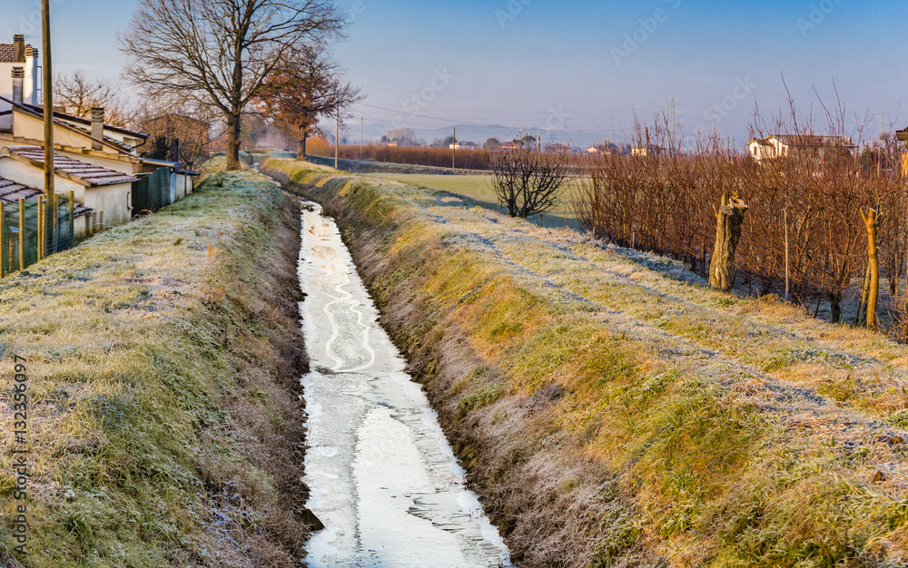 Fototapeta premium Frozen irrigation canal
