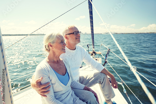 senior couple hugging on sail boat or yacht in sea © Syda Productions