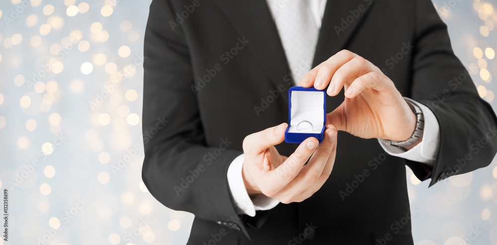 close up of man with engagement ring in gift box close up of man with engagement ring in gift box