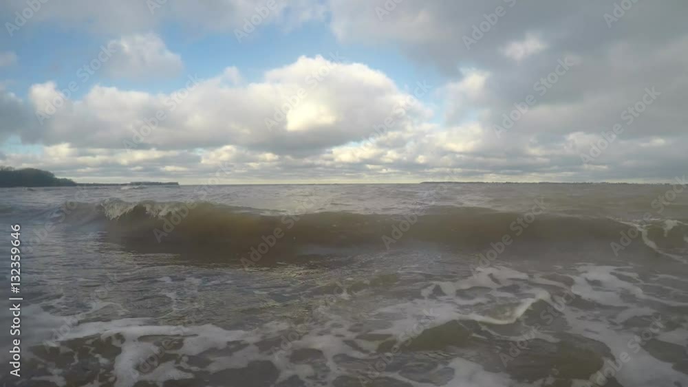 Waves on the Baltic sea beach with dirty water after a storm Waves on the Baltic sea beach with dirty water after a storm