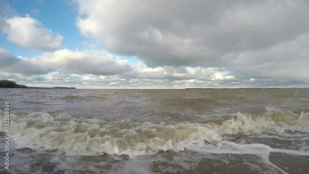 Waves on the Baltic sea beach with dirty water after a storm Waves on the Baltic sea beach with dirty water after a storm