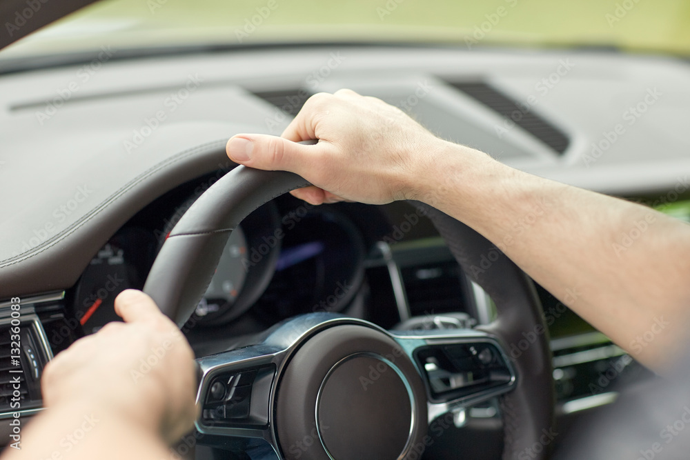 close up of male hands driving car