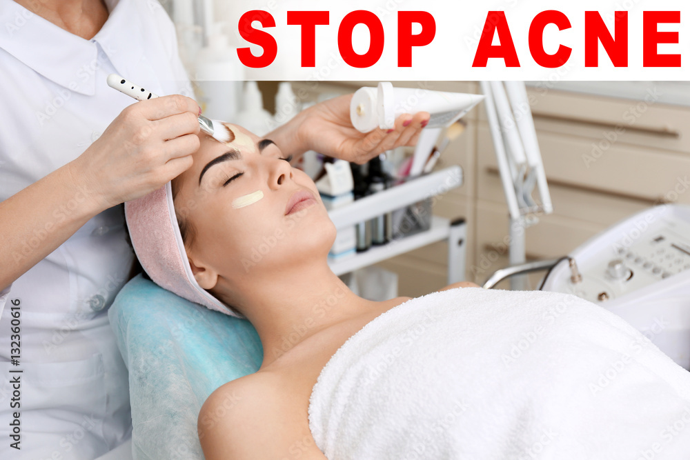 Dermatologist applying mask on woman's face. Text STOP ACNE on background Dermatologist applying mask on woman's face. Text STOP ACNE on background