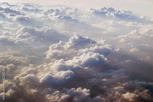 View of clouds from plane in beams of the sunset sun © Aikon