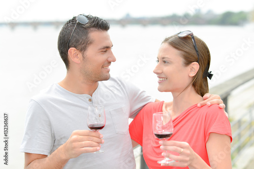 Couple enjoying wine by the river