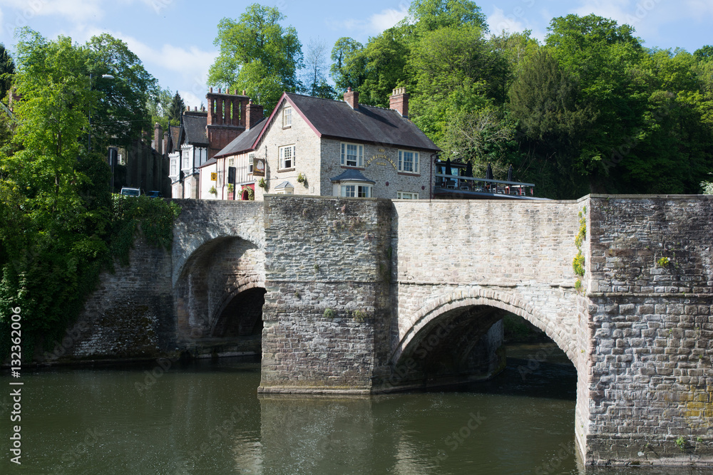 Old stone bridge over an English river. 