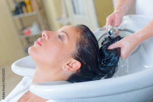 Lady having hair washed in salon