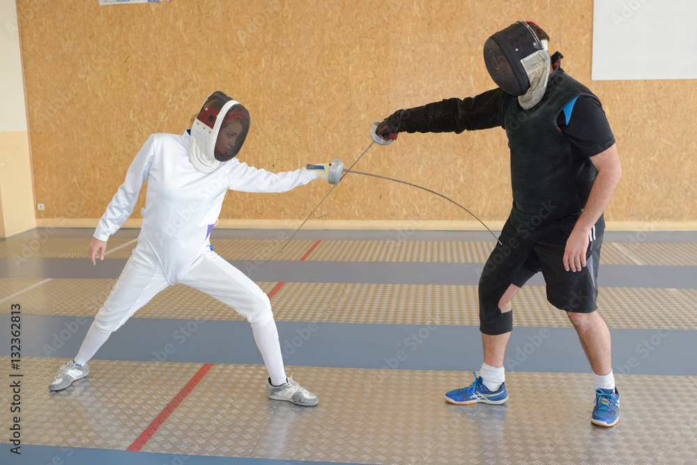 Two people in fencing competition Two people in fencing competition