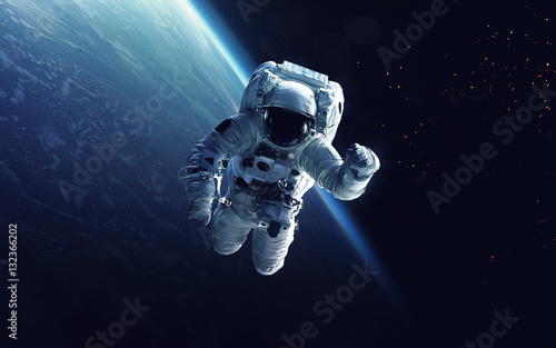 Astronaut at spacewalk. Cosmic art, science fiction wallpaper. Beauty of deep...