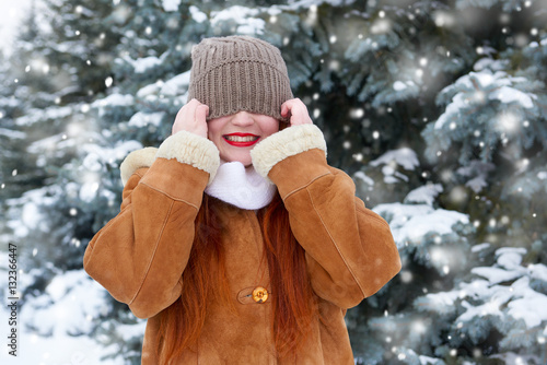 Obraz na plátně beautiful woman on winter outdoor, snowy fir trees in forest, long red hair, wea