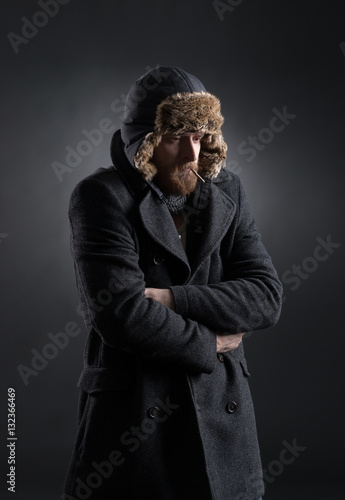 Portrait of a man getting cold in winter clothes