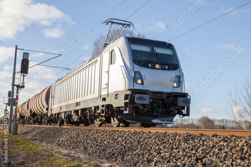 german cargo train drives on tracks to freight yard