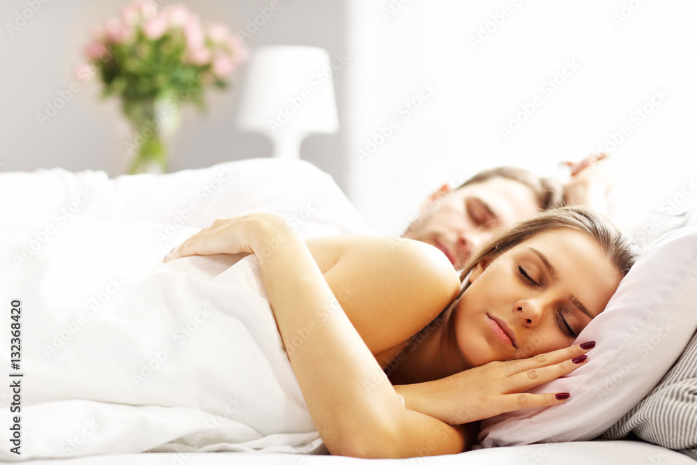 Obraz premium Young couple sleeping in bed