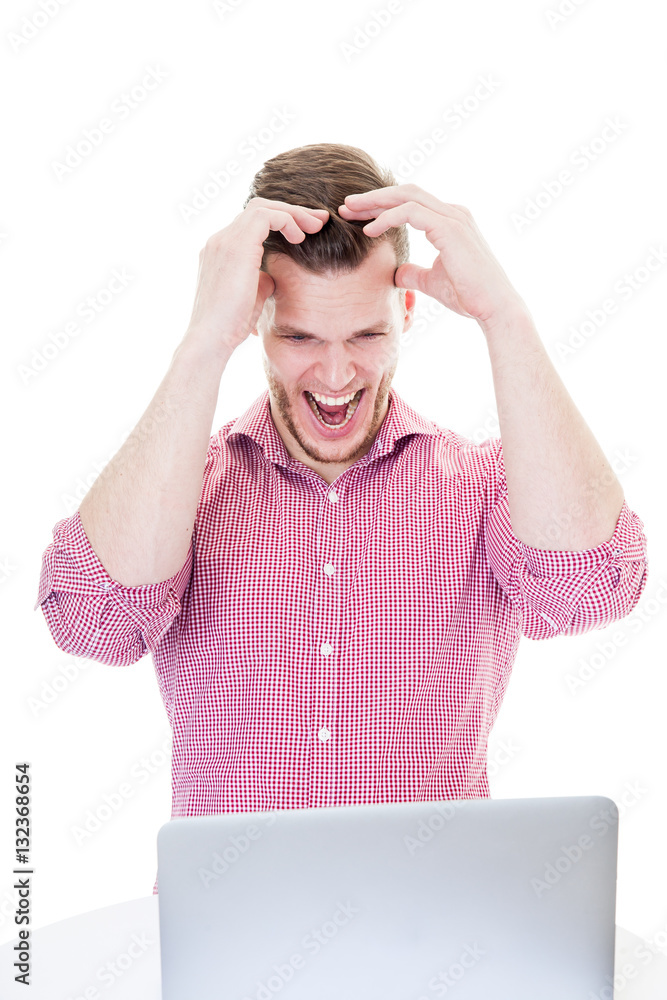 Young man frustrated with the laptop, isolated on white backgrou Young man frustrated with the laptop, isolated on white backgrou