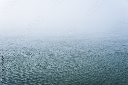 Water surface covered with fog.