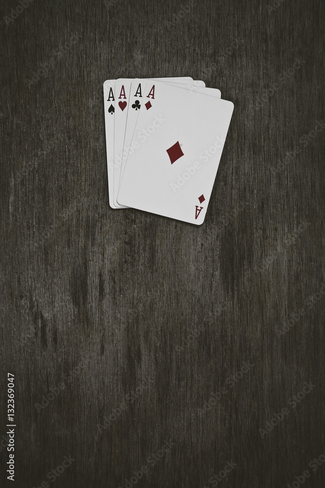 four aces playing cards on a wooden background. risk, luck, abstraction. Space for your text or object