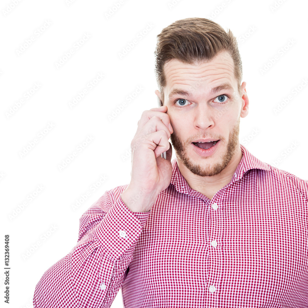 Young shocked man talking on his mobile phone isolated on white Young shocked man talking on his mobile phone isolated on white