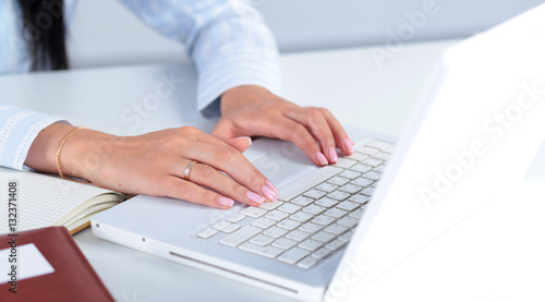 Woman working on laptop  sitting at the desk