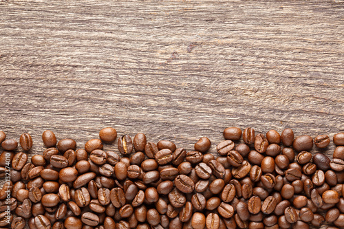 Coffee beans on wooden background © smuay