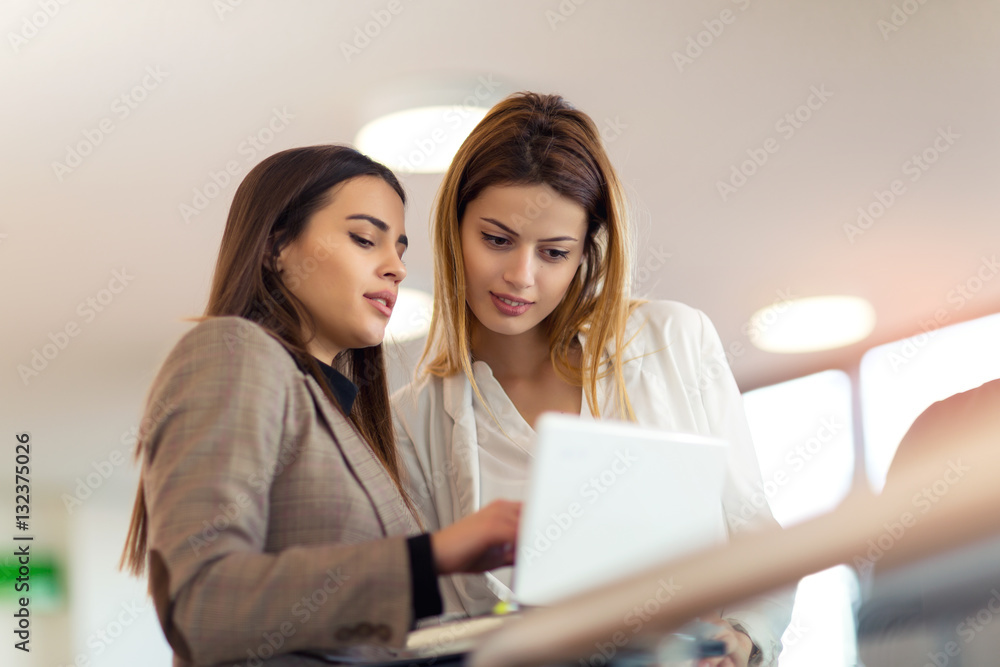 Two business women talking at office building Two business women talking at office building