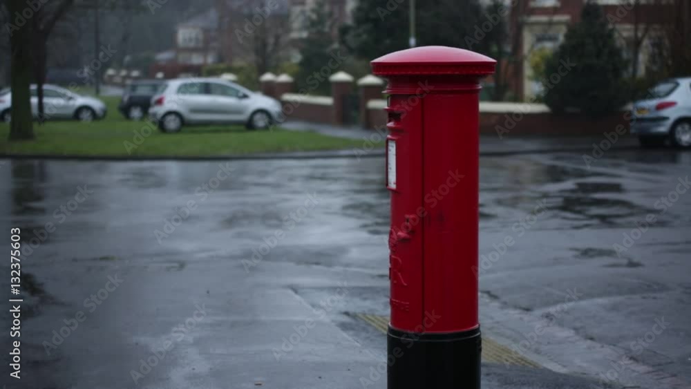 Typical English Red post box in a rain in England Typical English Red post box in a rain in England