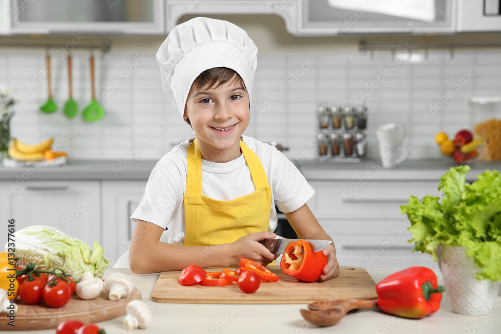 Cute boy cooking in kitchen at home Cute boy cooking in kitchen at home