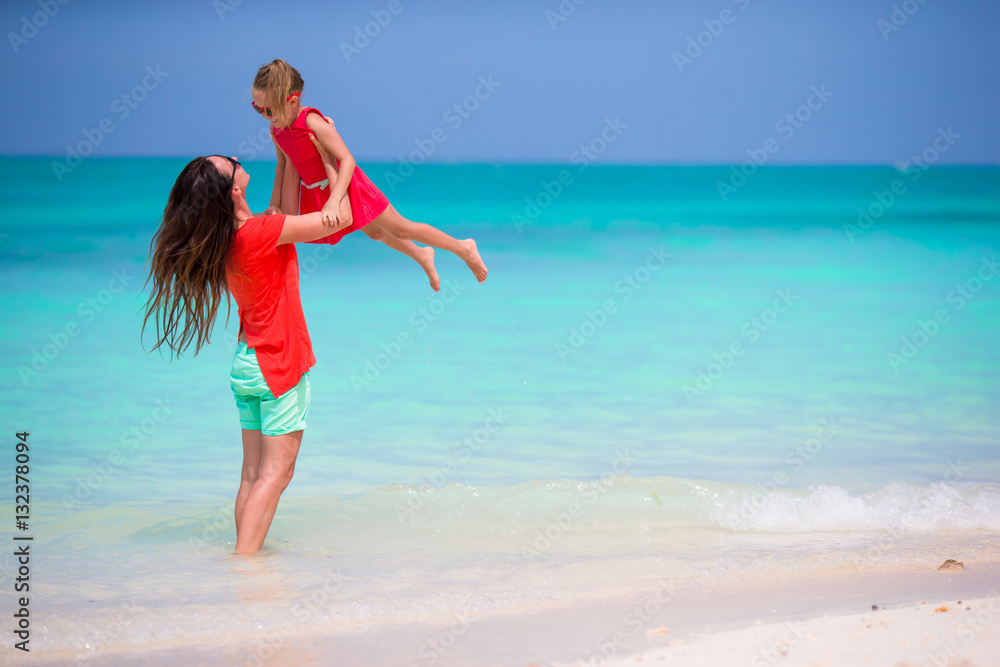 Mother and little daughter enjoying time at tropical beach Mother and little daughter enjoying time at tropical beach