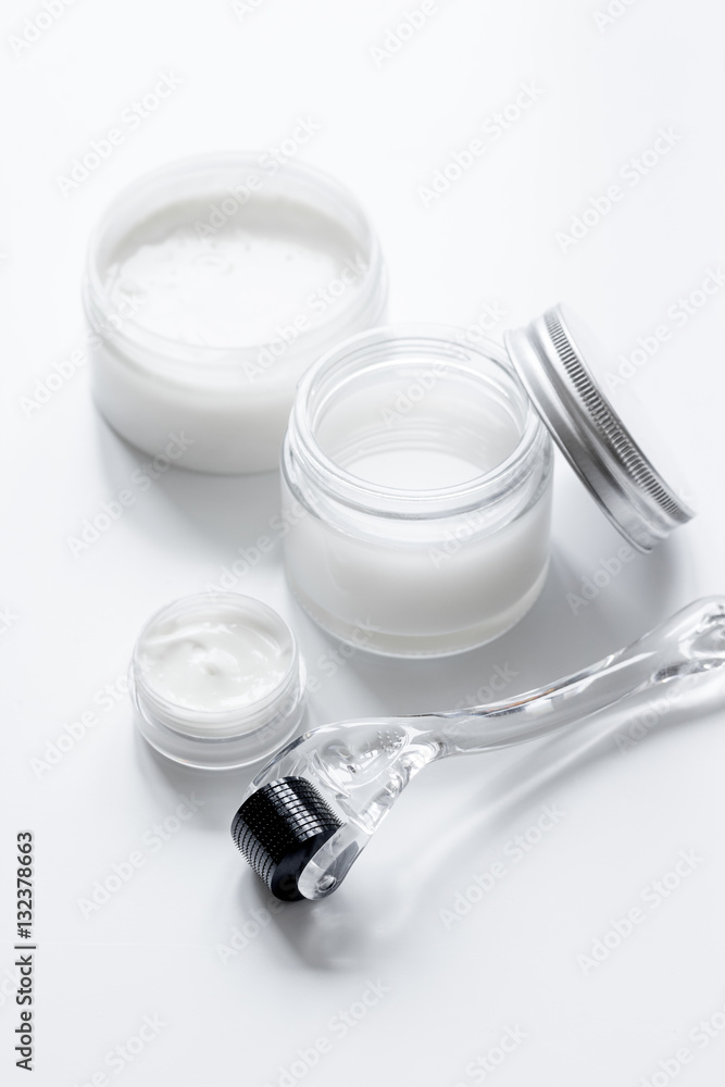 concept cosmetologist desktop with mezoroller - mesotherapy on white background concept cosmetologist desktop with mezoroller - mesotherapy on white background