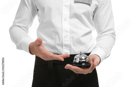 Closeup of waiter holding bell on white background © Africa Studio
