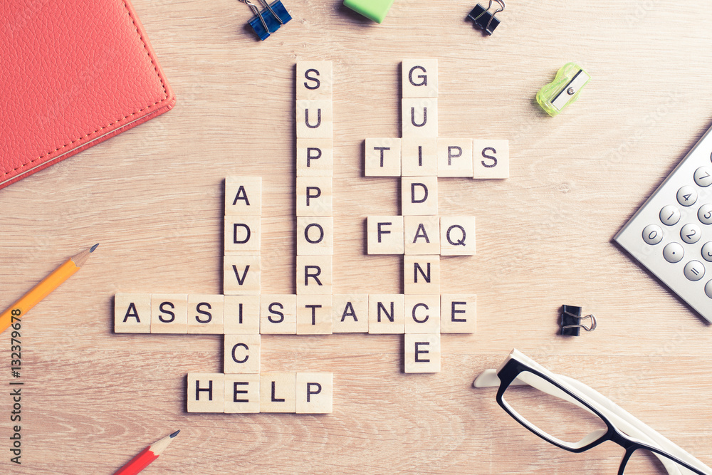 Conceptual media keywords on table with elements of game making crossword
