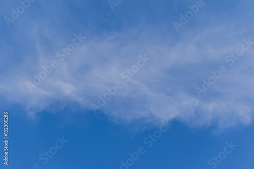 Blue sky background with tiny clouds