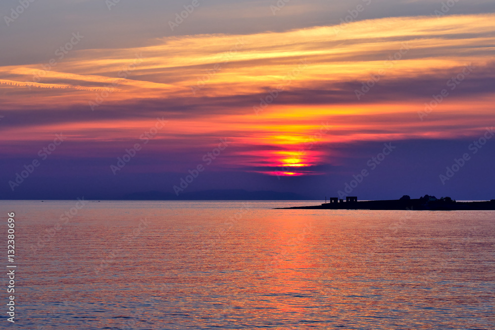 Beautiful Aegean Sea sunset with vibrant clouds. Greek travel destinations poster..