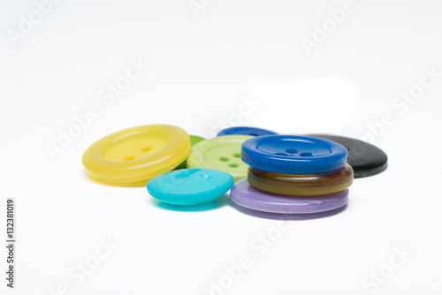 Pile of colorful sewing plastic buttons on white background 
