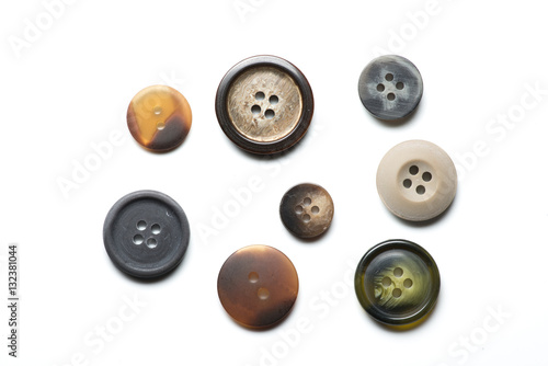 Collection of eight sewing buttons on white background 
