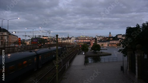 Railroad tracks in Stockholm. Passenger train and cityscape photo