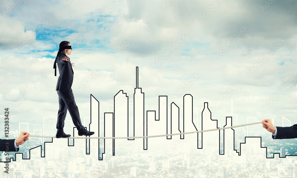 Business concept of risk support and assistance with man balancing on rope Business concept of risk support and assistance with man balancing on rope