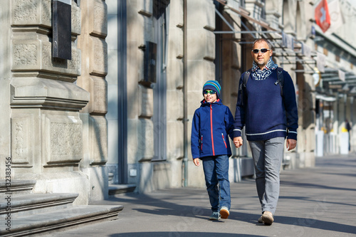 Father and son walking in city