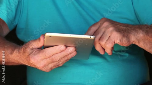 Wallpaper Mural Close up of Old man is using an electronic tablet Torontodigital.ca