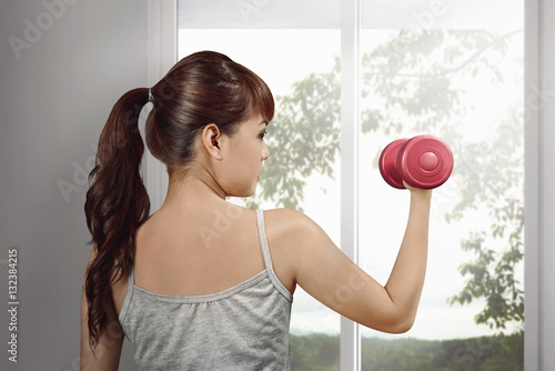 Portrait of asian woman exercising with dumbbells