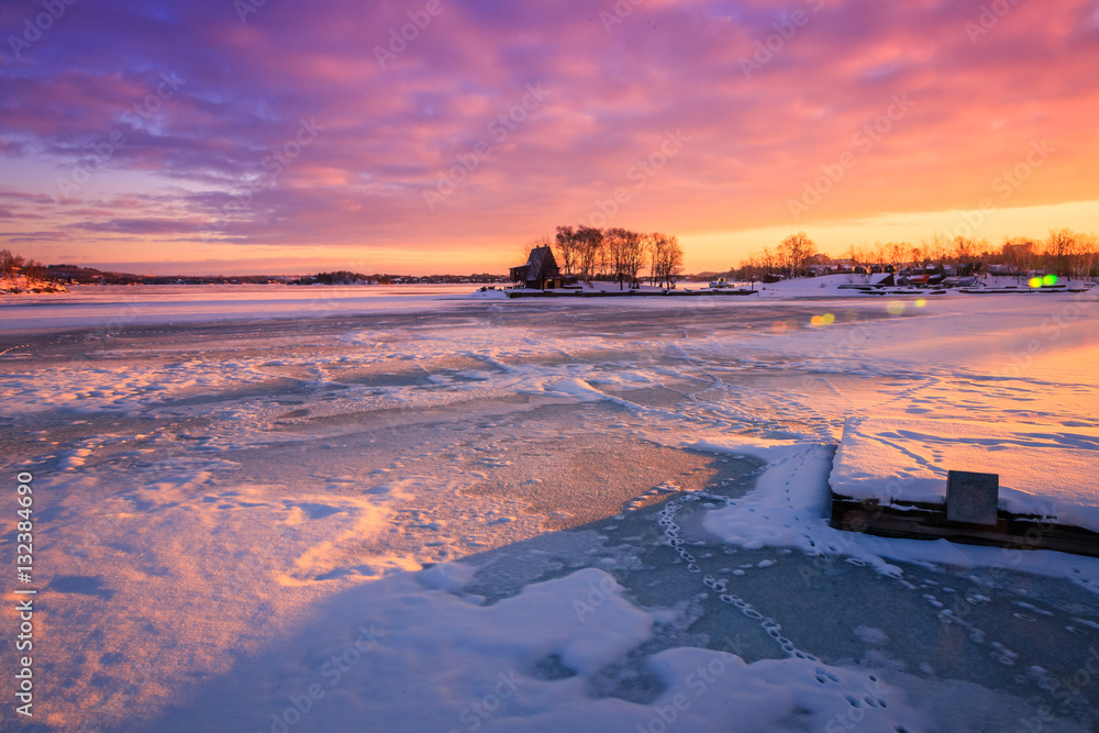 Fototapeta premium View of a frozen lake during sunrise in winter season. Location: Ramsey Lake, Ontario, Canada