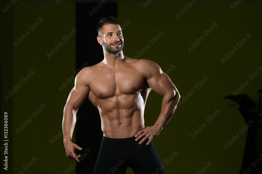 Muscular Man Flexing Muscles In Gym Muscular Man Flexing Muscles In Gym