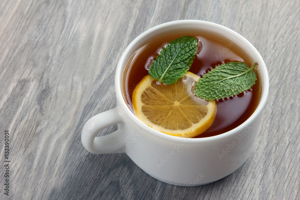 white cup of tea with lemon and mint white cup of tea with lemon and mint