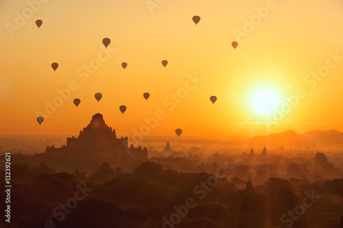 Beautiful sunrise and hot air balloons over ancient pagoda in Ba