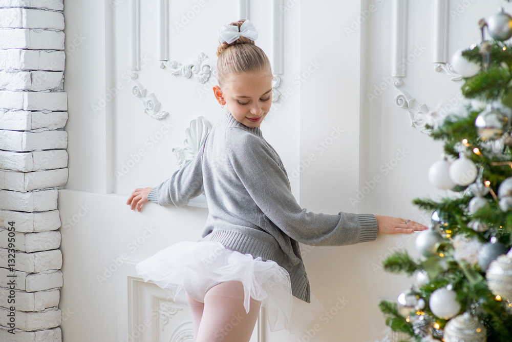 Fototapeta premium Young ballet dancers learning the lesson near Christm