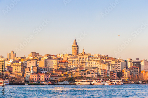 Sunset view of Galata tower and historical Karakoy district over Golden Horn gulf, Istanbul, Turkey
