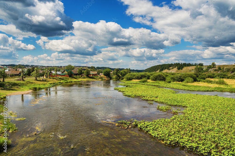 Beautiful rural landscape with river and clouds
