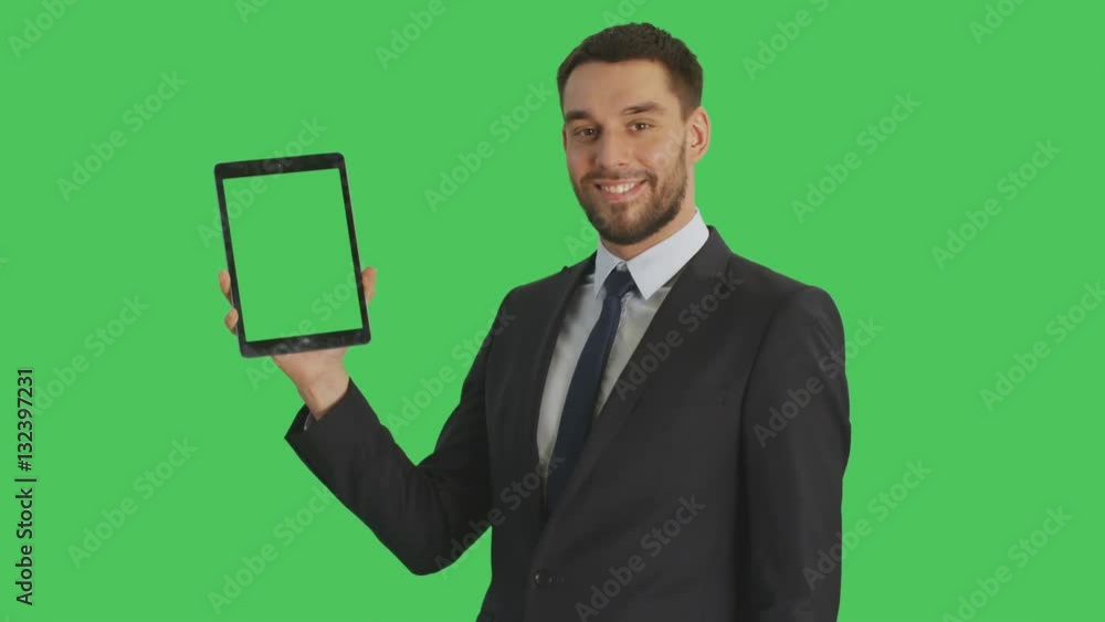 Mid Shot of a Handsome Businessman Holding Tablet Computer with One Hand and Making Swiping Touching Gestures with Another. Tablet and Background are Green Screen. Shot on RED Cinema Camera 4K (UHD). Mid Shot of a Handsome Businessman Holding Tablet Computer with One Hand and Making Swiping Touching Gestures with Another. Tablet and Background are Green Screen. Shot on RED Cinema Camera 4K (UHD).