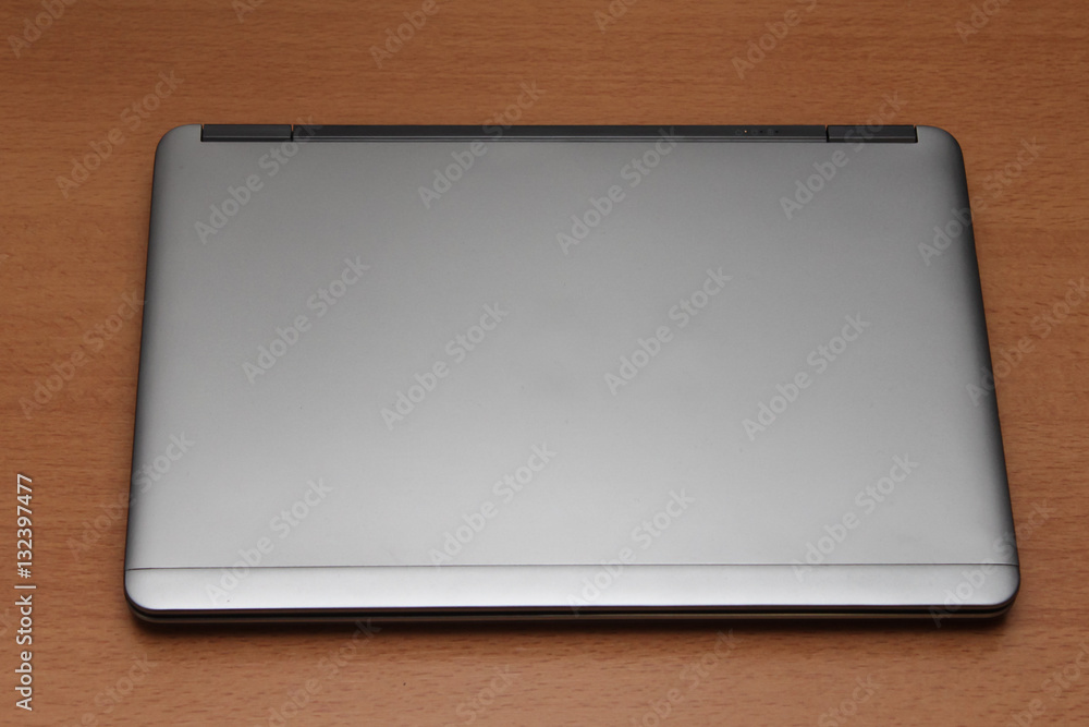 Sleek stylish silver ultra notebook on desk. Computer Sleek stylish silver ultra notebook on desk. Computer
