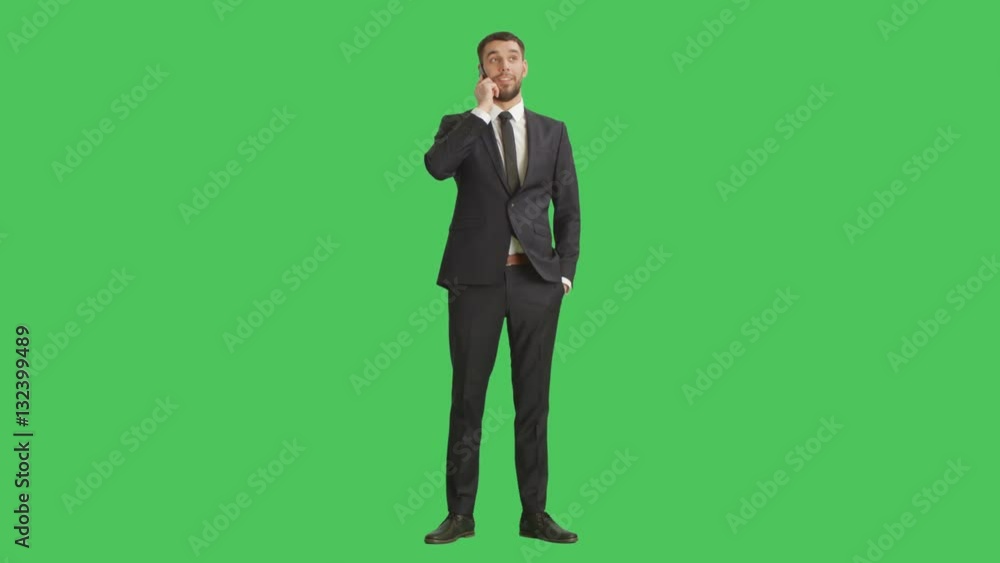 Long Shot of a Handsome Businessman Answers His Phone. Background is Green Screen. Shot on RED Cinema Camera 4K (UHD). Long Shot of a Handsome Businessman Answers His Phone. Background is Green Screen. Shot on RED Cinema Camera 4K (UHD).