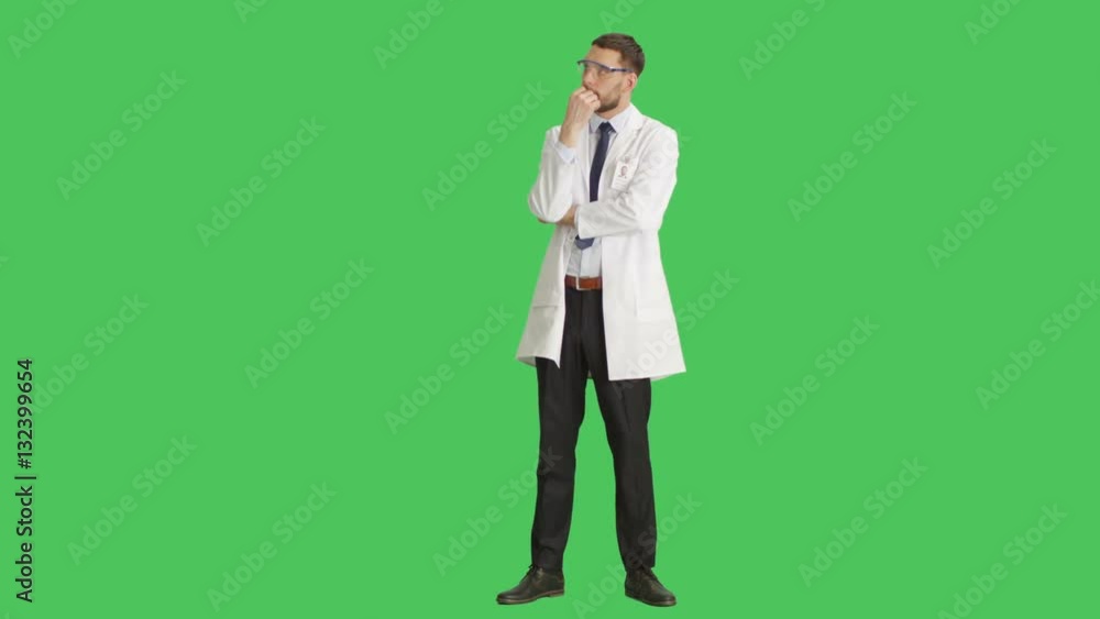 Long Shot of a Handsome Scientist Wearing Protective Glasses Making Touching Chin Thinking Gesture. Background is Green Screen. Shot on RED Cinema Camera 4K (UHD). Long Shot of a Handsome Scientist Wearing Protective Glasses Making Touching Chin Thinking Gesture. Background is Green Screen. Shot on RED Cinema Camera 4K (UHD).